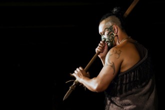 Maori warriors with traditional face painting and tattoo at a cultural performance in Rotorua,