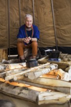 A person is sitting in a teepee at the Norwegian stand at the Green Week at the exhibition center