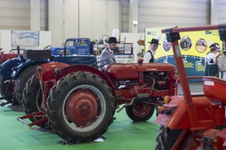 Visitors look at old agricultural machinery as part of the special exhibition on 100 years of Green