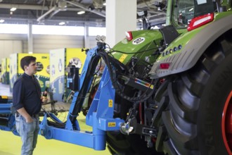 A visitor looks at a tractor as part of the special exhibition on 100 years of Green Week at the