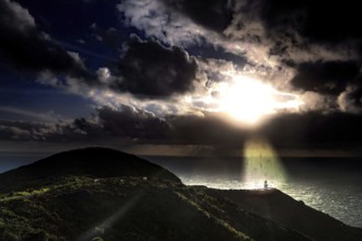 Sunset over the ocean at Cape Reinga with rolling clouds and rays of light, Cape Reinga, Northland,