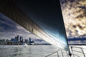 Sailing trip in dramatic atmosphere with views of Auckland City in the evening, Auckland, region,