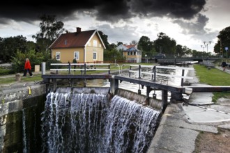Lock area on Göta Canal in Berg with a picturesque house and dramatic clouds, Berg, Östergötland,