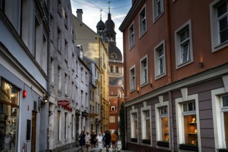 Narrow street in Riga with a view of the cathedral and picturesque houses, Riga, Latvia