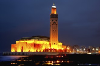 Illuminated Hassan II mosque at night, magnificent architecture on the coast of Casablanca,