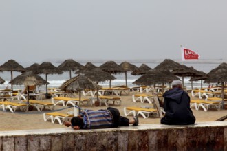 Umbrellas and sun loungers line Agadir beach, where gentle waves break, Agadir, Morocco