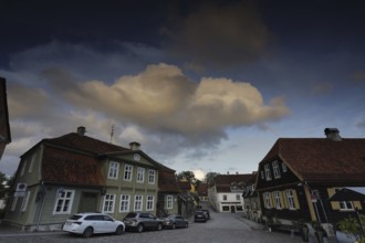 Kuldiga Town Hall Square, Rathausplatz, Rathausplatz with historic buildings and parked cars at