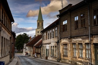 Street view with St. Catherine's Church and historic buildings in the old town, Kuldiga, Latvia