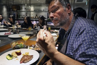 Guest enjoying Kobe steak at Kobe Plaisir restaurant, Kobe, Japan