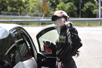 A gas station attendant in Kyoto interacts in a friendly manner with a customer, Kyoto, Kyoto,