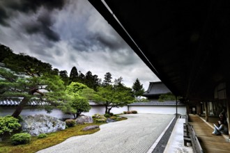 Tora Yaku no Niwa Zen Garden with carefully arranged rocks and sand patterns surrounded by nature,
