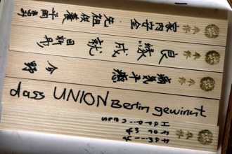 Ema wooden plates with Japanese characters and small symbols, traditionally used in temples, Kyoto,