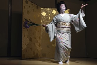 Geisha dances gracefully in traditional kimono at Nishi Chaya tea house, Kanazawa, Japan