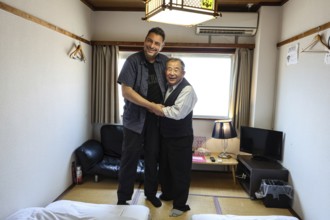 Smiling host and guest pose in traditional lodging in Kanazawa, Kanazawa, Japan