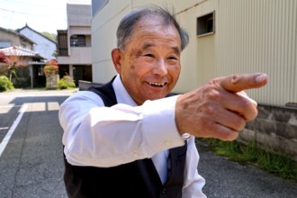 Friendly host points smiling in one direction in Kanazawa, Kanazawa, Japan