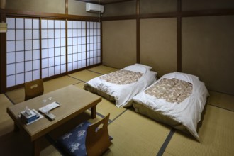 Japanese room with tatami flooring and two beds in a ryokan, Kawaguchi, Yamanashi, Japan