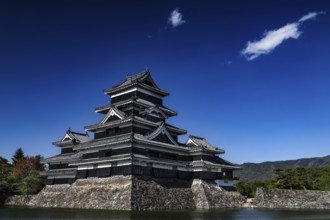 Matsumoto Castle surrounded by water and blue sky, Matsumoto, Nagano, Japan