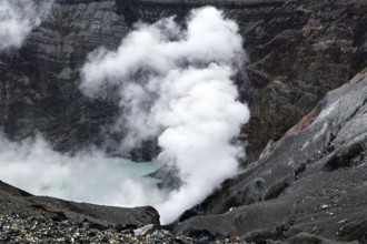 Crater with steaming water and steep rock walls, Aso, Kumamoto, Japan