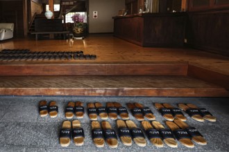 Entrance to Ryokan Minshuku Asogen with carefully arranged shoes