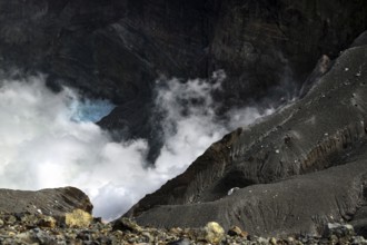Morning light illuminates Nakadake crater in Aso with rising fog, Aso, Kyushu, Japan