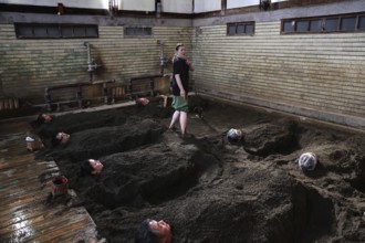Visitors to Takegawara Onsen are deeply relaxed in sand baths, Beppu, Oita, Japan