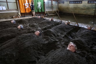 Attendees enjoy a unique sand bath at Takegawara Onsen in Beppu, Beppu, Oita, Japan