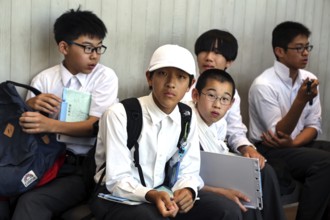 Students relax at Hiroshima Peace Museum after visiting, Hiroshima, Japan