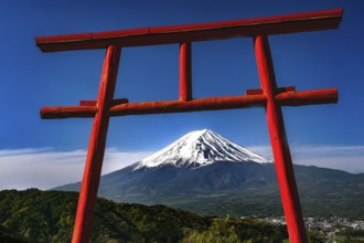 Red torii with a view of snow-capped Mount Fuji in Kawaguchi-ko, Kawaguchi-ko, Yamanashi, Japan