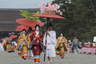 Traditional procession with geishas and red umbrellas during Aoi Matsuri in Kyoto, Kyoto, Japan