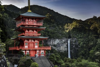Sublime pagoda in front of a majestic waterfall in wooded surroundings, Nachi, Wakayama, Japan
