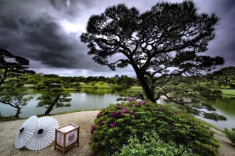 Jardin in Korakuen with a view of the lake and dramatic sunbeams through the clouds, Okayama,