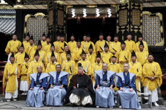 Ceremonial group photo of Shinto priests wearing traditional dress in front of Toshogu Shrine,