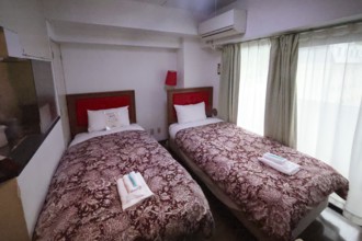 Hotel room with twin beds, brown blankets and red headboard, Nikko, null, Japan