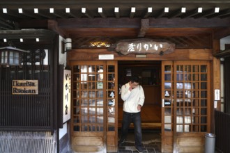 Entrance of Karya Ryokan in Yanouchi with traditional wooden design