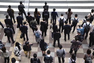 People gather at a busy pedestrian crossing, Osaka, Umeda, Japan