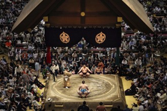 Sumo competition at Ryogoku Kokugikan Hall with concentrated audience, Tokyo, Japan