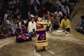Sumo wrestler performs the ceremony with a bow swivel in Kokugikan, Tokyo, Ryogoku, Japan