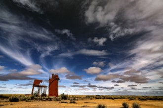 Abandoned water tower under dramatic sky on Oodnadatta Track, Curdimurka, South Australia,