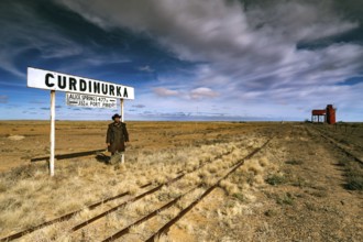 Abandoned station sign and water tower along a dusty track, Curdimurka, Oodnadatta Track, South