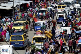Heavy traffic and crowds in an urban market