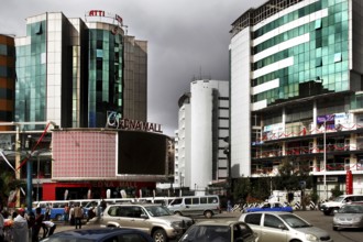 Modern city scene in Addis Ababa with tall buildings and heavy traffic under a cloud-covered