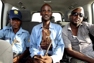 Three people sit in a Landcruiser in Ahmedela while talking, Ahmedela, Ethiopia