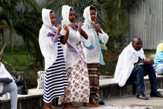 Women wearing religious clothing pray together in front of a church in Addis Ababa, Addis Ababa,