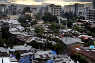 View of buildings and vegetation with dramatic evening sky, Addis Ababa, Ethiopia