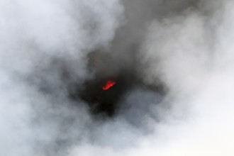 Smouldering volcano with a crater partly covered by haze, Erta Ale, Ethiopia