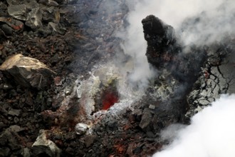 Lava and steam in a rugged volcanic environment, Erta Ale, Ethiopia