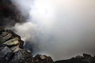 Smoke rises from a volcanic crater and obscures the view, Erta Ale, Ethiopia