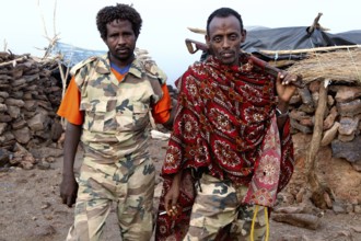 Two soldiers in traditional and military clothing at Erta Ale Camp, Erta Ale, Ethiopia