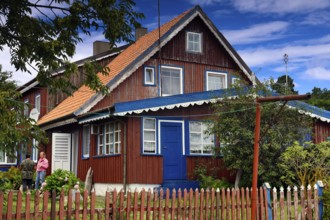 Traditional Lithuanian wooden house with colorful exterior and garden, Nida, Curonian Spit,
