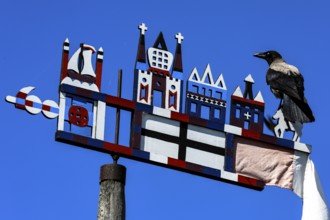 Colourful Kuren pennant with a bird on a bright sky, symbolism of the Curonian Spit, Nida, Curonian